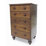 Victorian mahogany narrow chest of five long drawers with turned handles, supported upon cup and