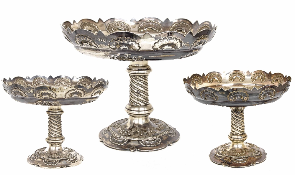 Late Victorian silver comport table garniture, with card-cut rims with shell motifs, over embossed
