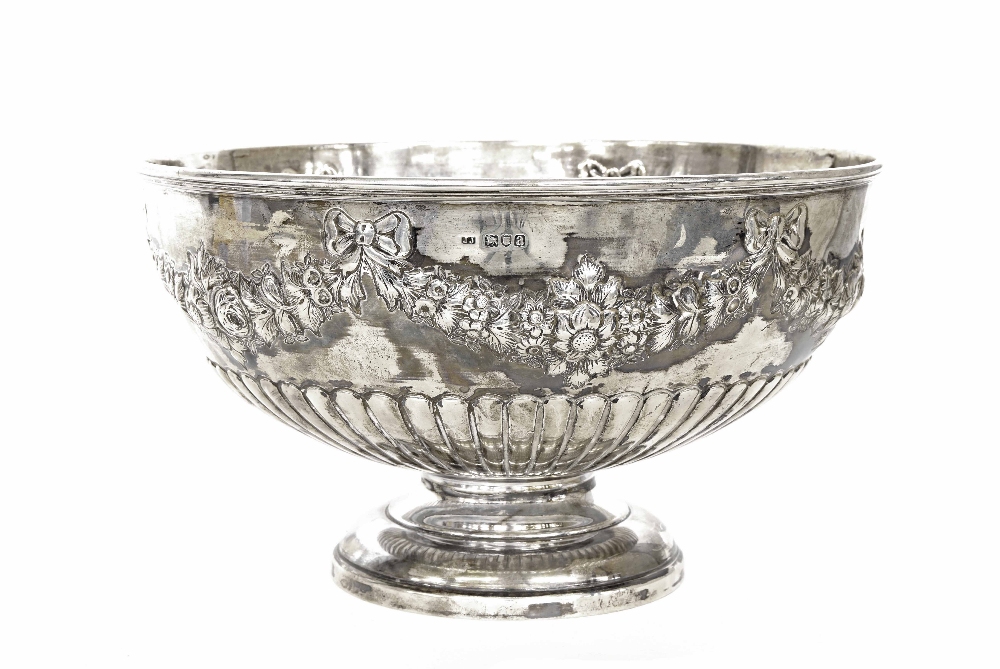 Good Late Victorian silver punch bowl, the half reeded body repousse with a foliate garland, maker