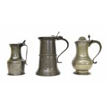 Three large decorative pewter lidded vessels, to include a French example, the largest tankard 13"
