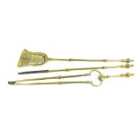 Set of three neoclassical style brass fire irons, with engraved knop finials and the shovel