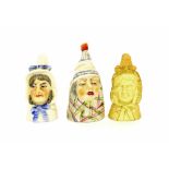 Three Royal Worcester porcelain candle snuffers depicting head studies, green and puce factory