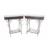 Pair of wrought iron and wirework plant stands, the tin plant stands upon open stands, 35" high, 34"