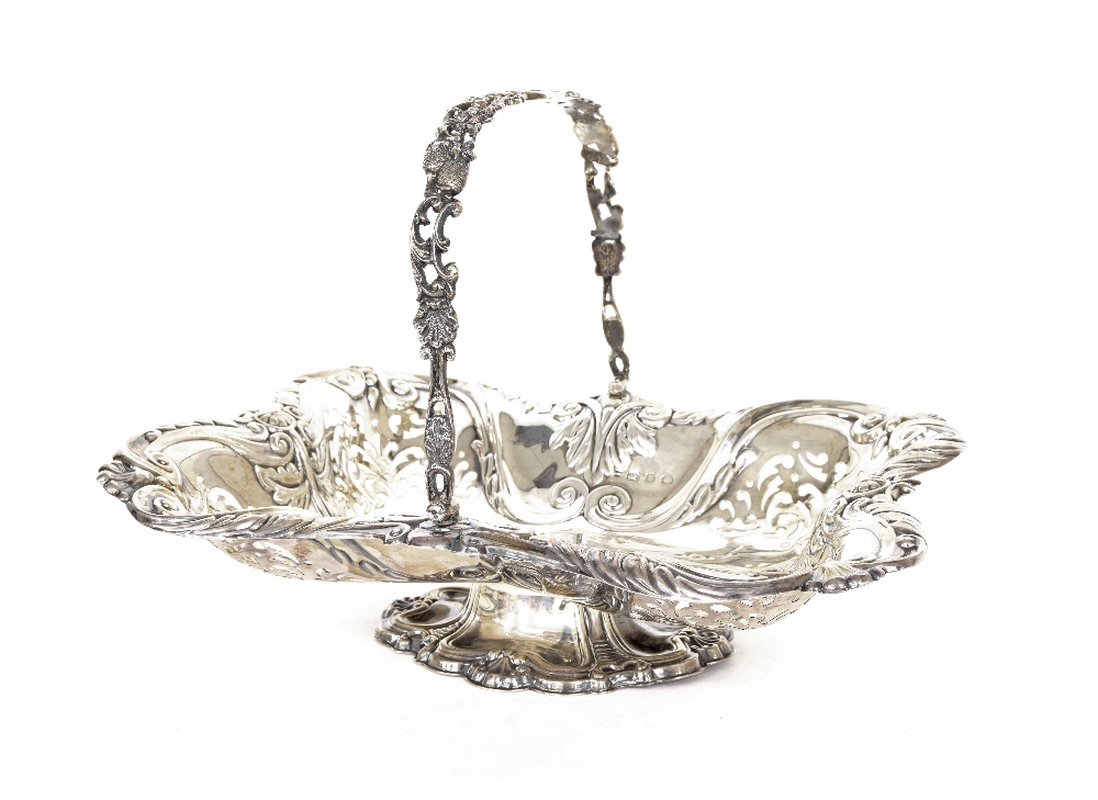 Late Victorian silver pierced oval cake basket, with foliate scroll decoration and a cast swing