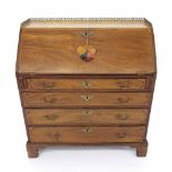 Small George III mahogany inlaid bureau, the fall front inlaid with a paterae opening to reveal a