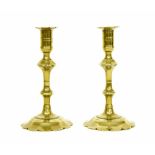 Pair of 18th century brass candlesticks, having double knop stems and petal bases, 8" high