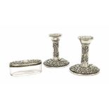 Pair of embossed silver table candlesticks, Birmingham 1968, 4" high; also an oval glass dressing