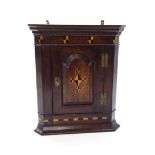 19th century small oak hanging corner cupboard, the single arched panelled door enclosing a