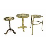 Three 19th century circular pierced brass trivets, the tallest 12" high (3)