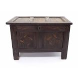 Small early 18th century oak panelled coffer, the hinged lid opening to reveal a candle box, the
