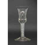 Antique cordial glass, the large bell bowl with bubble inclusions on an opaque twist stem and