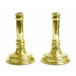 Pair of heavy brass alloy candlesticks, with cylindrical reeded barrel turned columns upon domed