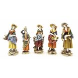 Set of four Continental painted porcelain figures depicting standing ladies in various pursuits, all