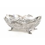 George V rectangular silver pierced basket, with a fret foliate decoration upon raised on stylised