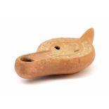 Roman terracotta oil lamp carved with a pipe player sitting in a tree house surrounded by animals,