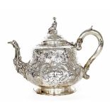 Good Victorian silver teapot, with repousse foliate scrolls and surmounted with a figural finial