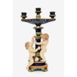 19th century Minton Majolica candelabra, modelled with two cherubs upon an oval base with scroll