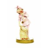 Continental porcelain figure modelled as a pixie eating an apple and holding a basket upon an oval