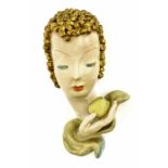 Goldscheider 'Eve' terracotta wall mask, modelled with golden hair and holding an apple, printed '