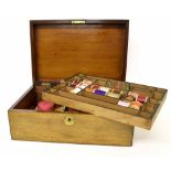 Victorian walnut sewing workbox, the interior with a pull-out tray and assorted cotton reels, 15.75"