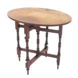 Burr walnut oval occasional side table upon a folding turned stand, bearing maker's label 'Robertson