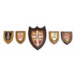 Five assorted armorial shield plaques, the largest 12.75" x 9.5" (5)