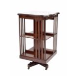 Edwardian mahogany square inlaid revolving bookcase, the top with satinwood banding over open