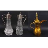 Two moulded glass and silver plated claret jugs, 11" high; together with an Eastern brass ewer (3)