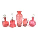 Victorian cranberry glass to include two decanters and stoppers, bell, jug and a tall vase with