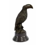 Decorative cast bronze figure of a toucan upon a circular marble socle, 10" high