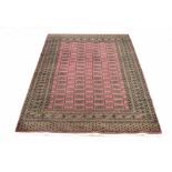 Bukhara type rug, on a purple ground, with four gul runs to the centre, 72" x 48" approx