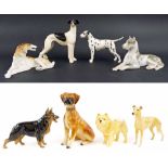 Eight assorted porcelain and pottery dog figurines, including two USSR examples (8)