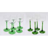 Set of four green and clear glass hocks with engraved foliate bowls, 8" high; together with five