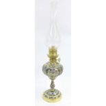 Contemporary cloisonne and brass oil lamp, the glass chimney supported upon a spherical reservoir,