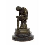 19th century bronze sculpture 'Spinario', a boy pulling a thorn from his foot, upon a circular