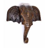 Carved oak wall plaque in the form of an elephant's head, 12" wide