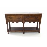 19th century oak dresser base, the rectangular top over two frieze drawers and shaped apron upon