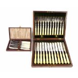 Cased set of twelve knives and forks with engraved silver plated blades, the box 11.5" wide;