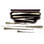 Victorian cased set to include a shoehorn, button hook and pair of glove tongs, each with silver