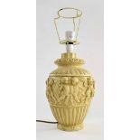 Decorative moulded plaster table lamp, decorated with a band of cherubs, base 12.5" high