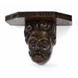 Antique carved oak head, detailing a gentleman with moustache, later bracket, probably 17th century,