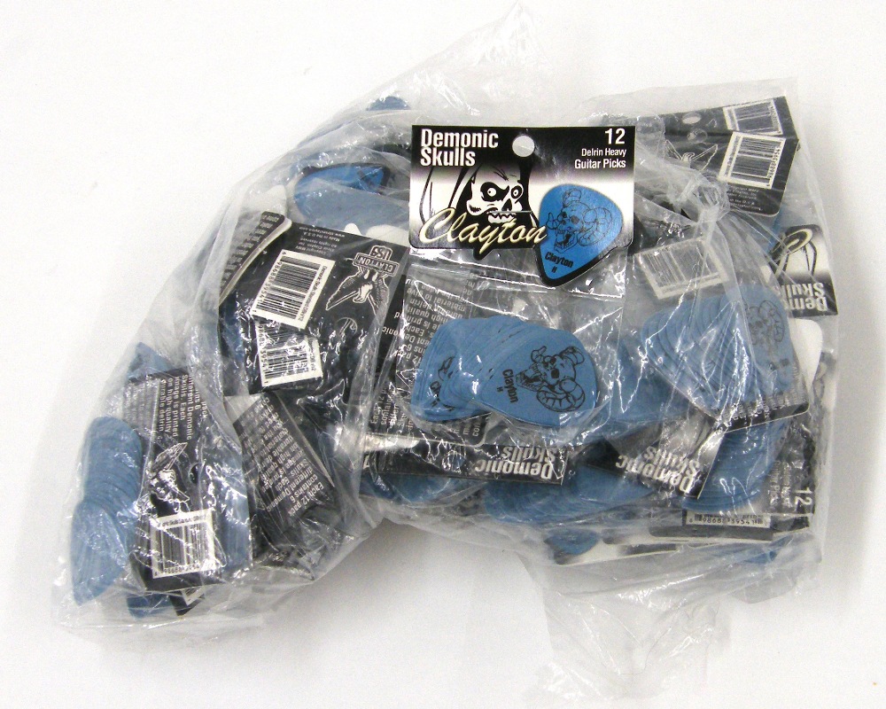 Approximately fifty-six Clayton Delrin Demonic Skulls heavy gauge guitar picks, each packet