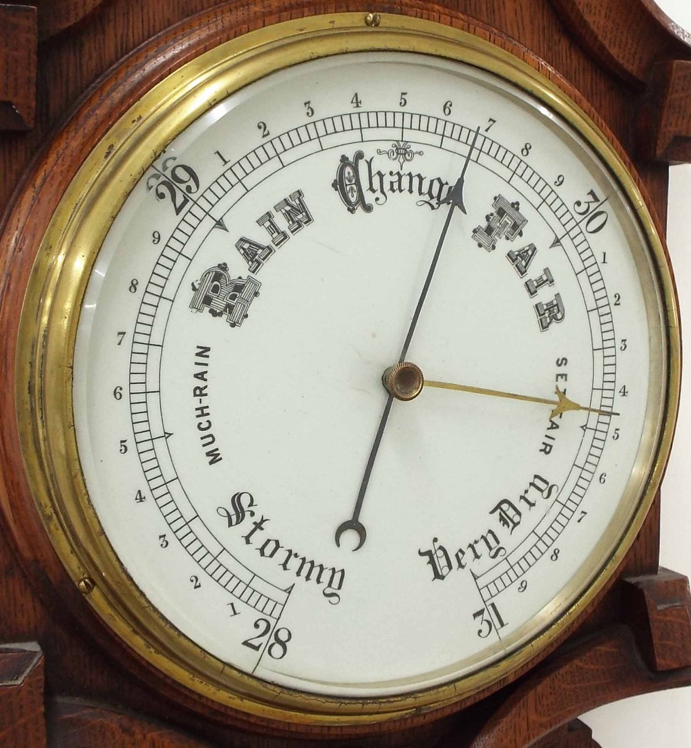 Oak barometer/thermometer, the 8" white dial within a good foliate carved shaped case *This - Image 2 of 3