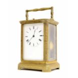 Repeater carriage clock striking on a bell, within a foliate engraved brass case, 6.75" high