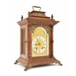 Lenzkirch oak two train mantel clock striking on a gong, the 4.5" brass arched dial with silvered