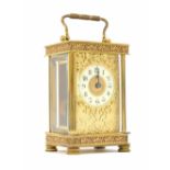 Brass carriage clock timepiece, the 1.75" cream chapter ring enclosing a gilt centre and within a