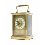 French brass carriage clock timepiece, the 1.75" cream chapter ring enclosing a gilded centre and