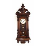Walnut Vienna two train calendar wall clock, the 5.25" white dial over three date apertures,