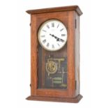 Rare Synchronome synchronous mains electric wall clock, the 6.25" silvered dial within an oak steppe