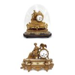 French spelter figural drumhead mantel clock timepiece, upon a shaped stand and under a glass